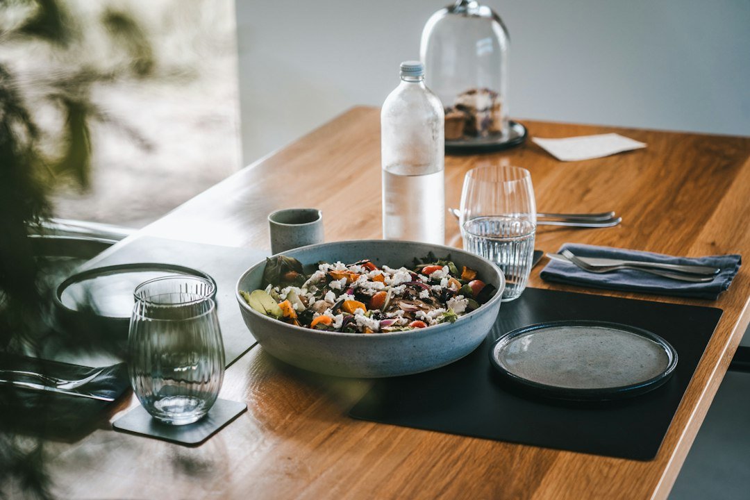 A bowl of food on a wooden table, a regular healthy meal