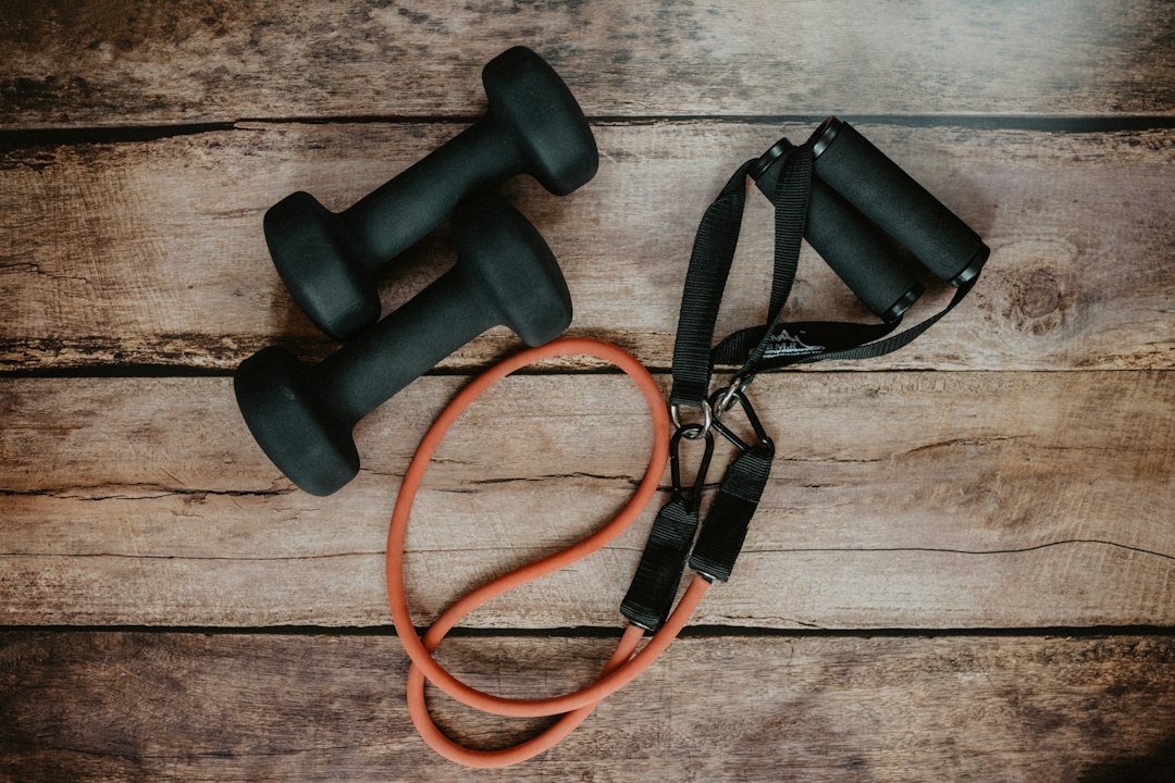 Simple home workout equipment including light weights and a mat