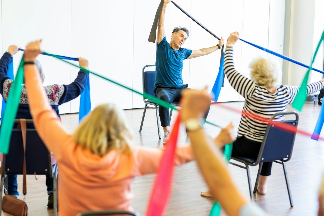 Older adults taking part in a gentle strength and fitness class